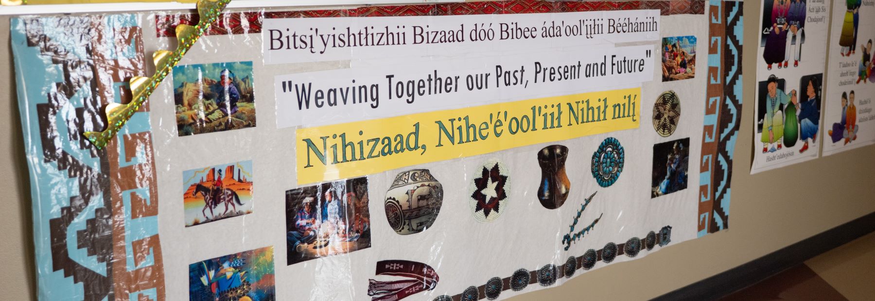 School bulletin board displaying various pictures of Native American people, showcasing their culture and heritage.