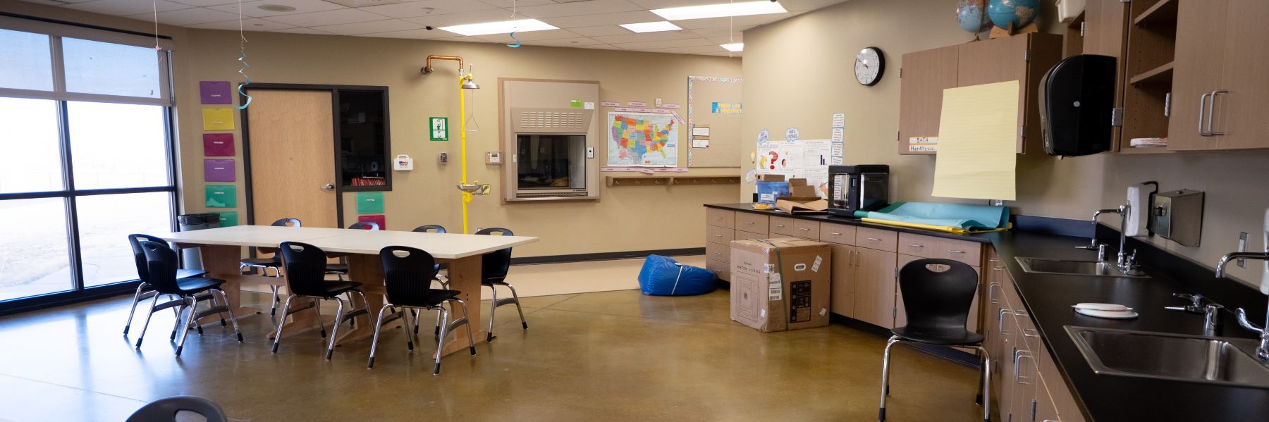 A school classroom featuring a table and chairs, ready for learning and activities.