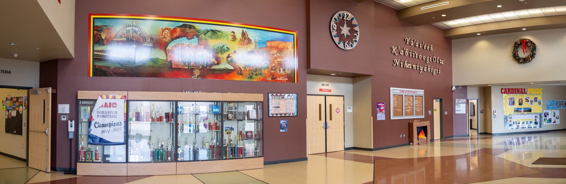 Bright school lobby with a large mural on the wall, enhancing the welcoming environment for students and guests.